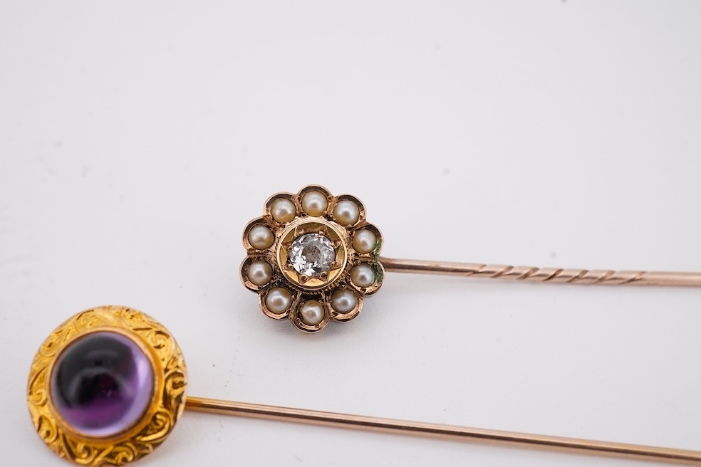 An Edwardian 15ct, diamond and seed pearl cluster set stick pin, 54mm, a similar yellow metal and cabochon garnet set stick pin and an Edwardian 9ct and gem set drop pendant. Condition - poor to fair